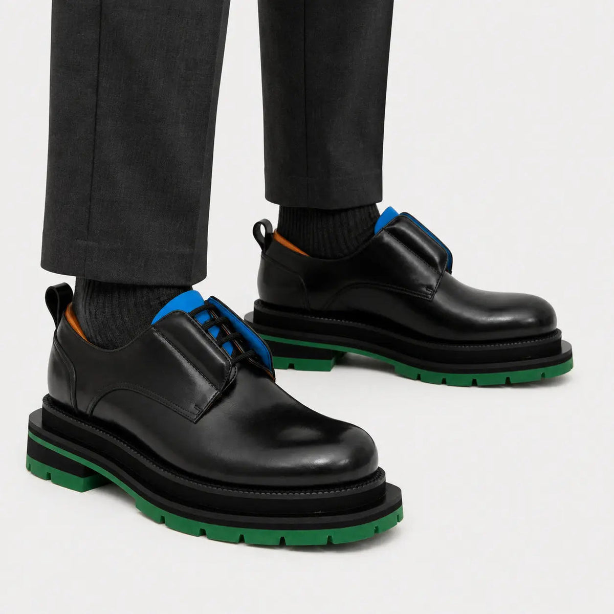 Black blue and green platform Derby shoes on foot