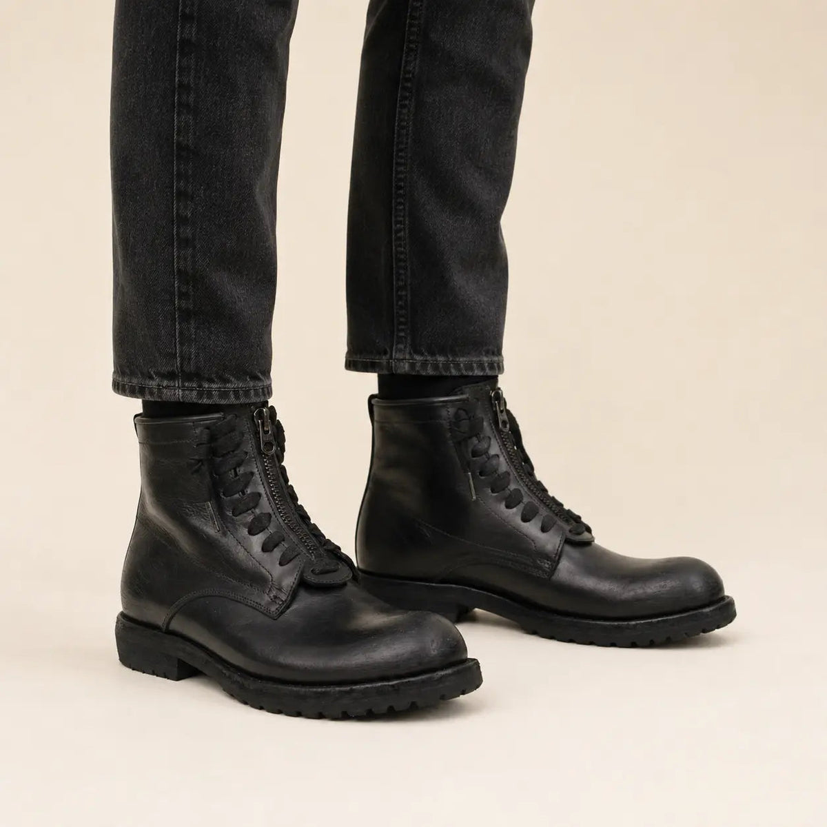 Black calf leather combat boots on-foot studio photo
