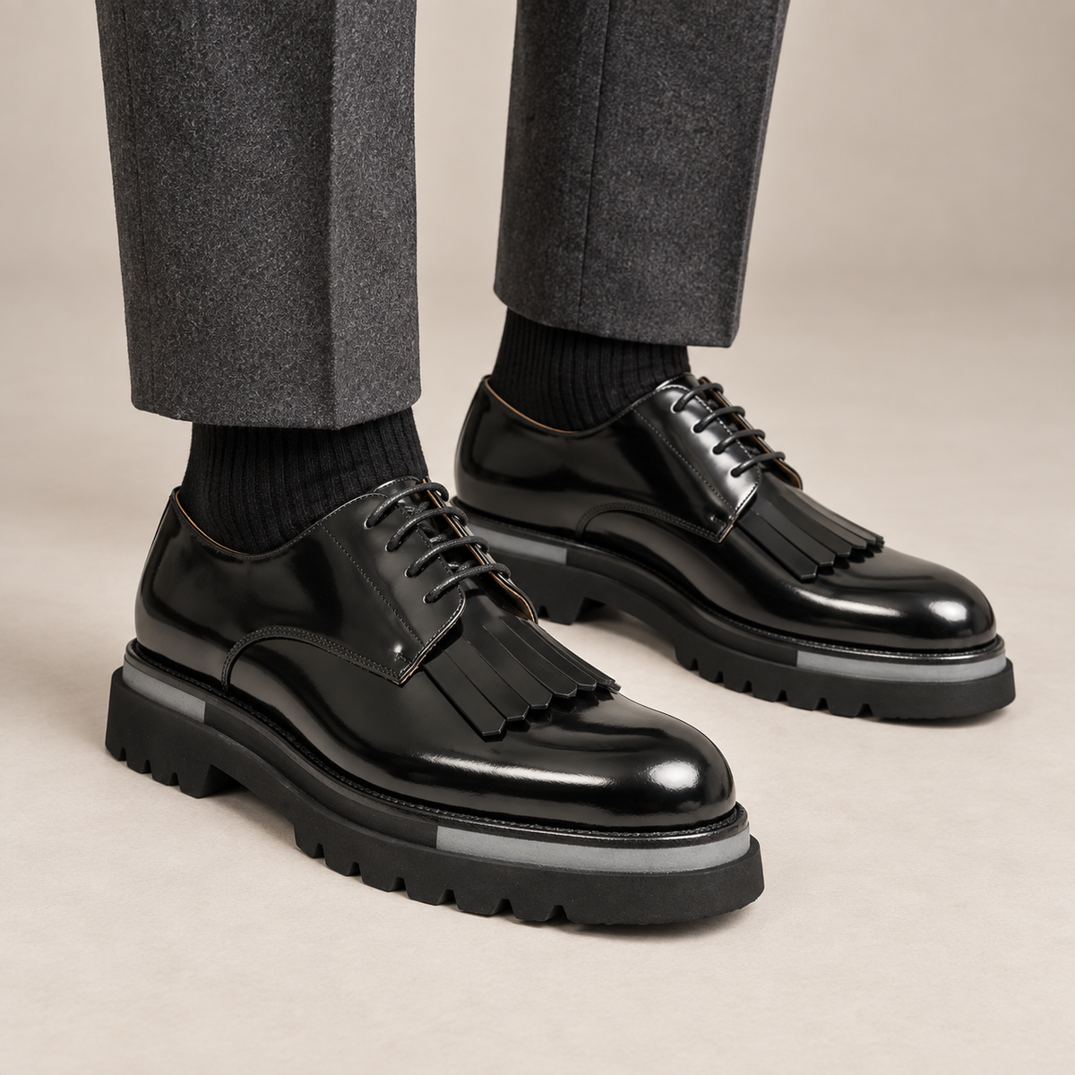 DIVINCH black glossy kiltie fringe Derby shoes worn with tailored charcoal trousers