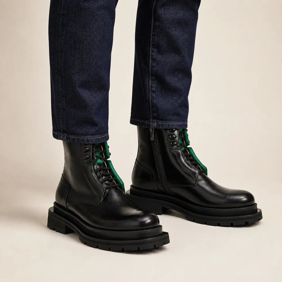Black side-zip lug sole boots with denim on-foot studio photo