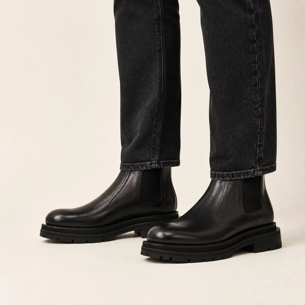 Black lug sole Chelsea boots on-foot studio photo