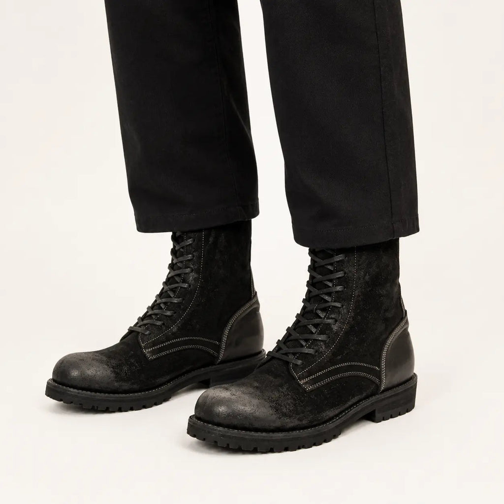 DIVINCH black suede lace-up combat boots on foot in warm studio
