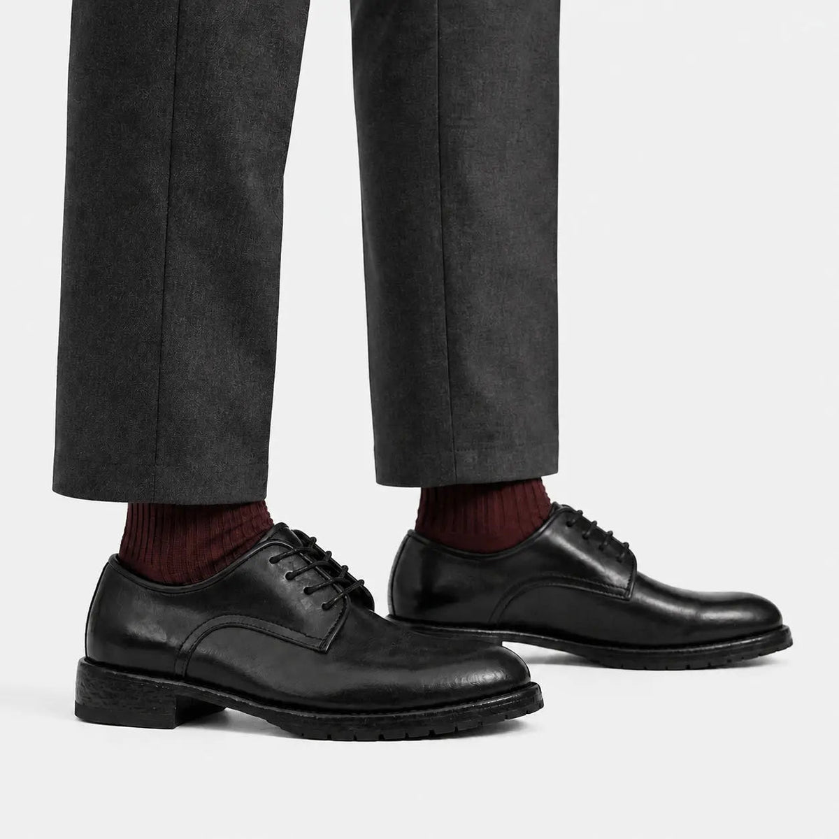 Black washed leather Derby shoes worn with charcoal trousers and burgundy socks
