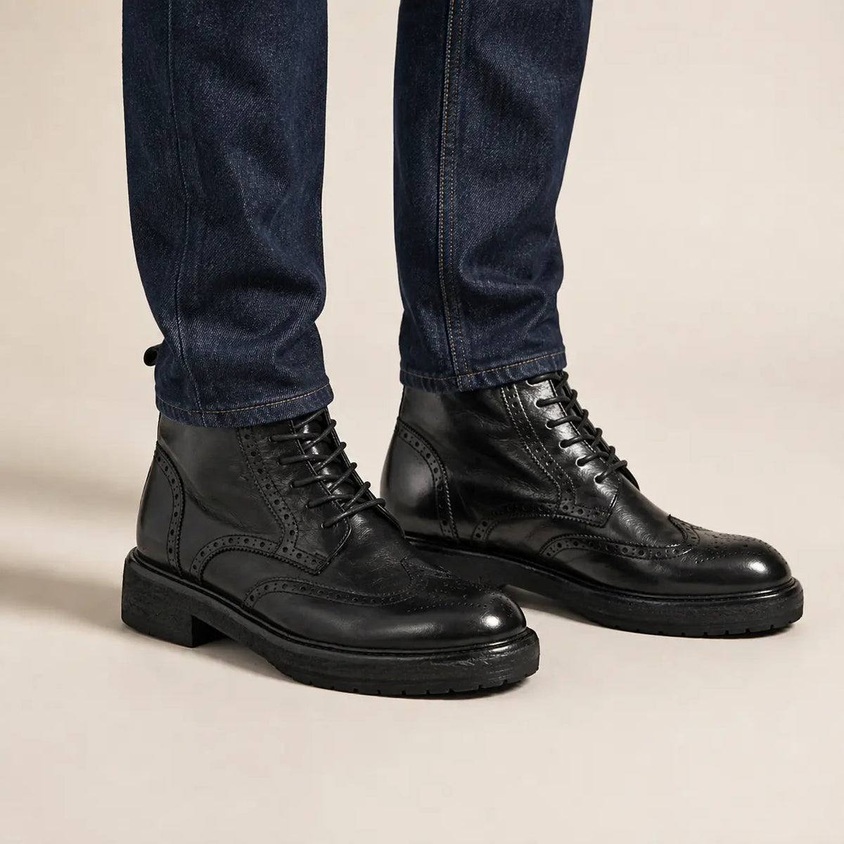 Black lace-up brogue ankle boots on foot