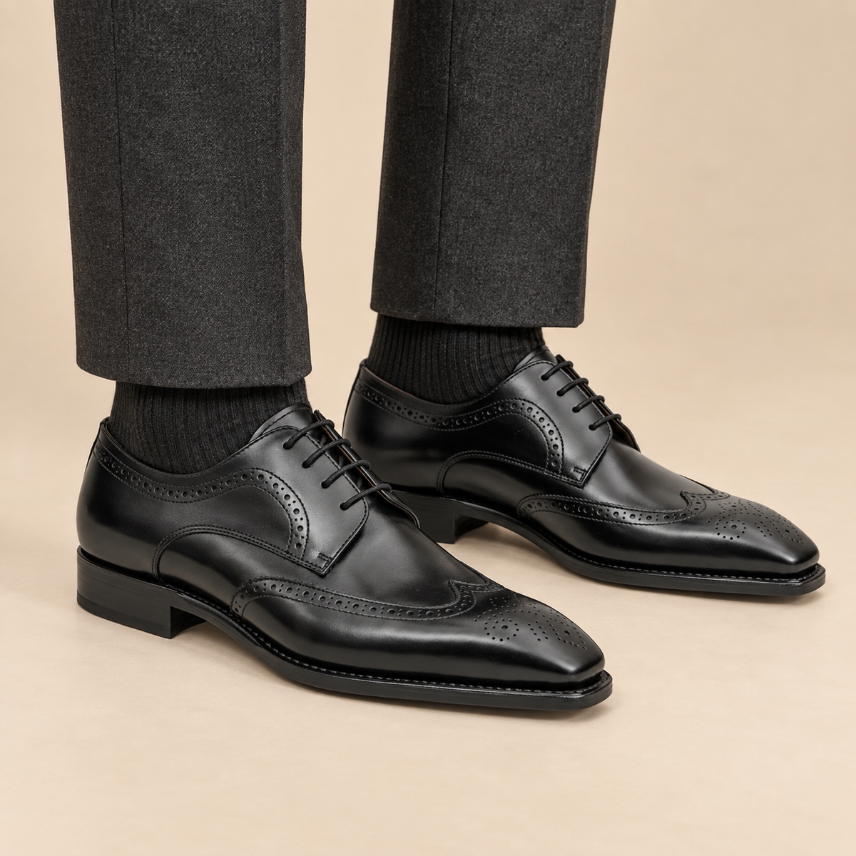 Black Calfskin Medallion Wingtip Derby Shoes — on-foot studio hero