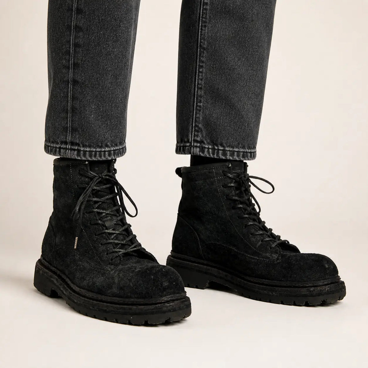 Black grey suede combat boots on-foot studio photo
