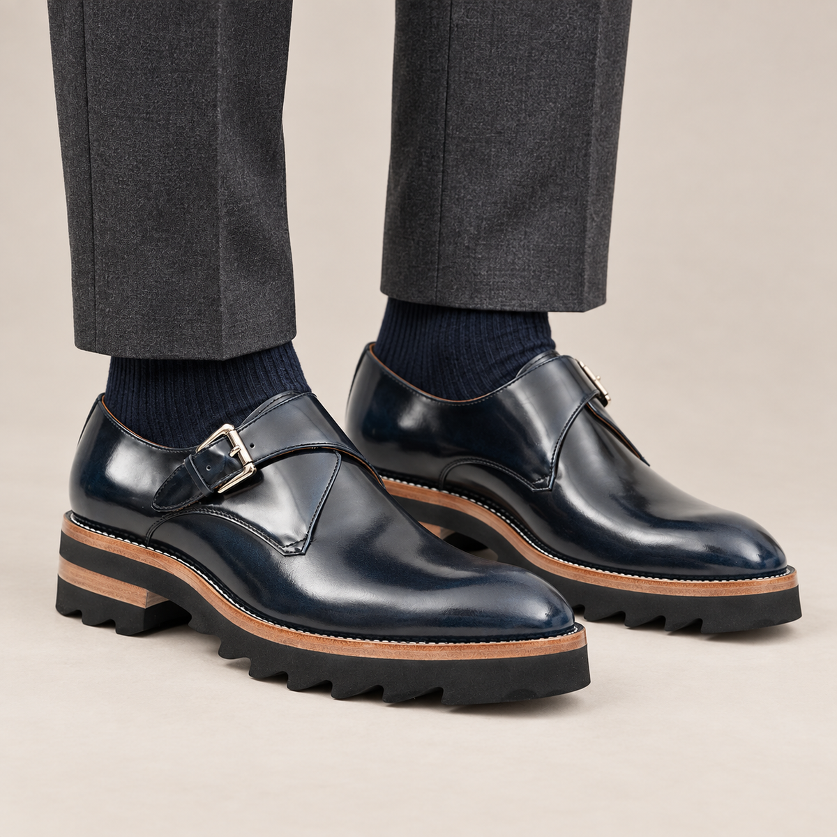 Dark blue single monk shoes with brown-band ridged sole — premium on-foot studio view