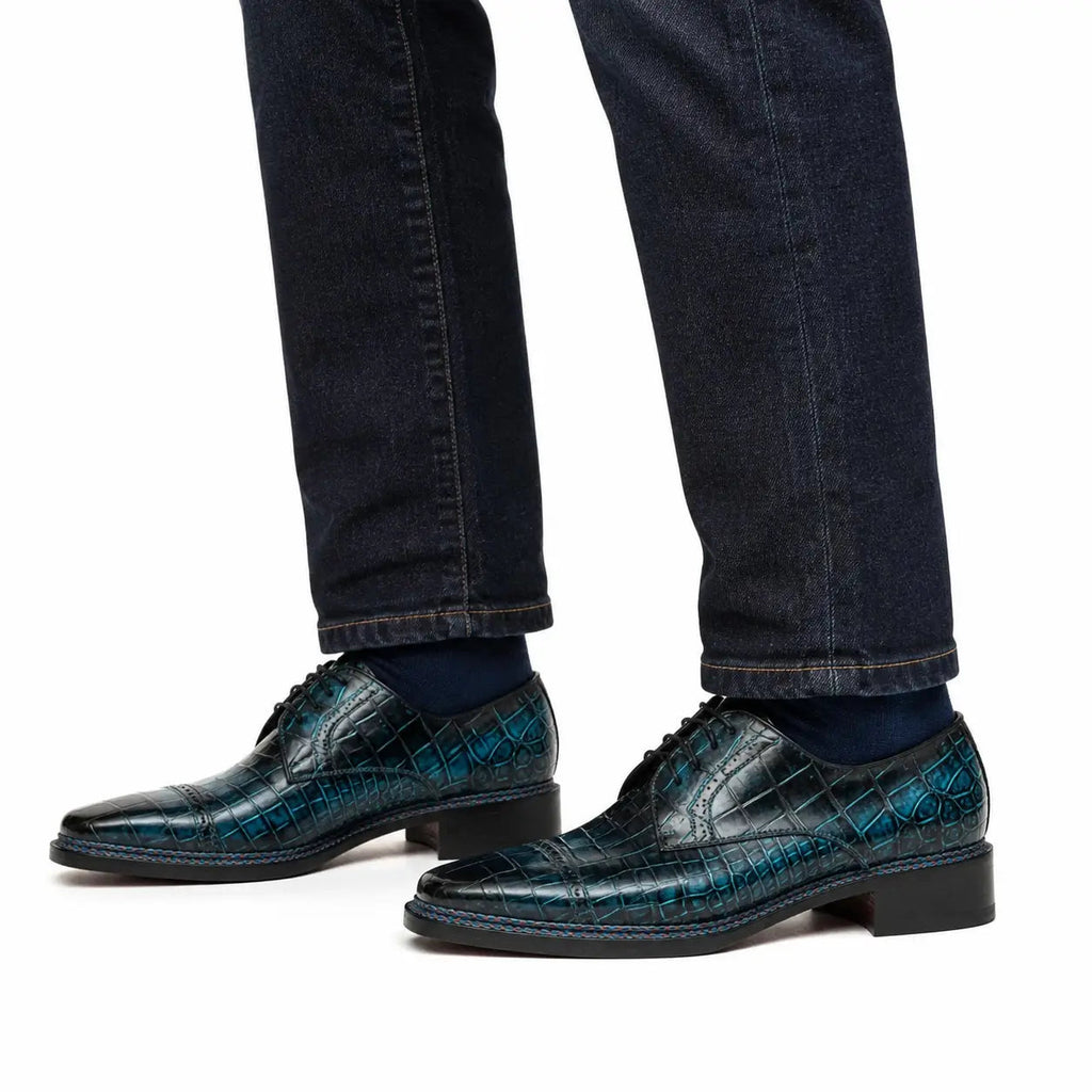 Blue crocodile cap-toe Derby shoes on foot