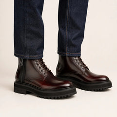 Bordeaux Zip Combat Boot — on-foot studio view with indigo denim