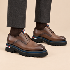 Taupe-brown plain-toe Derby shoes with pull tab on model
