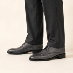 Charcoal crocodile-textured Derby shoes on foot