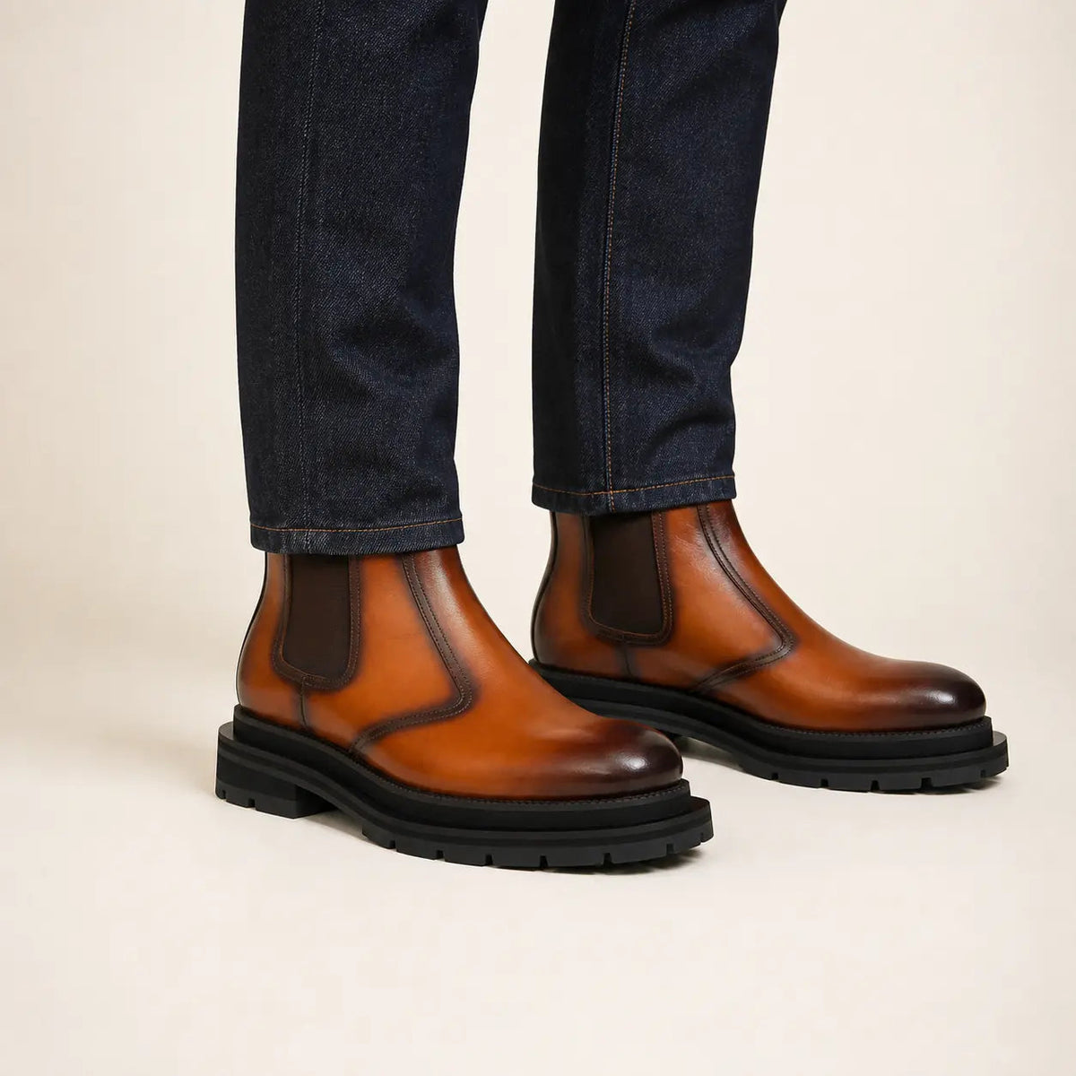 Cognac burnished Chelsea boots on-foot studio photo
