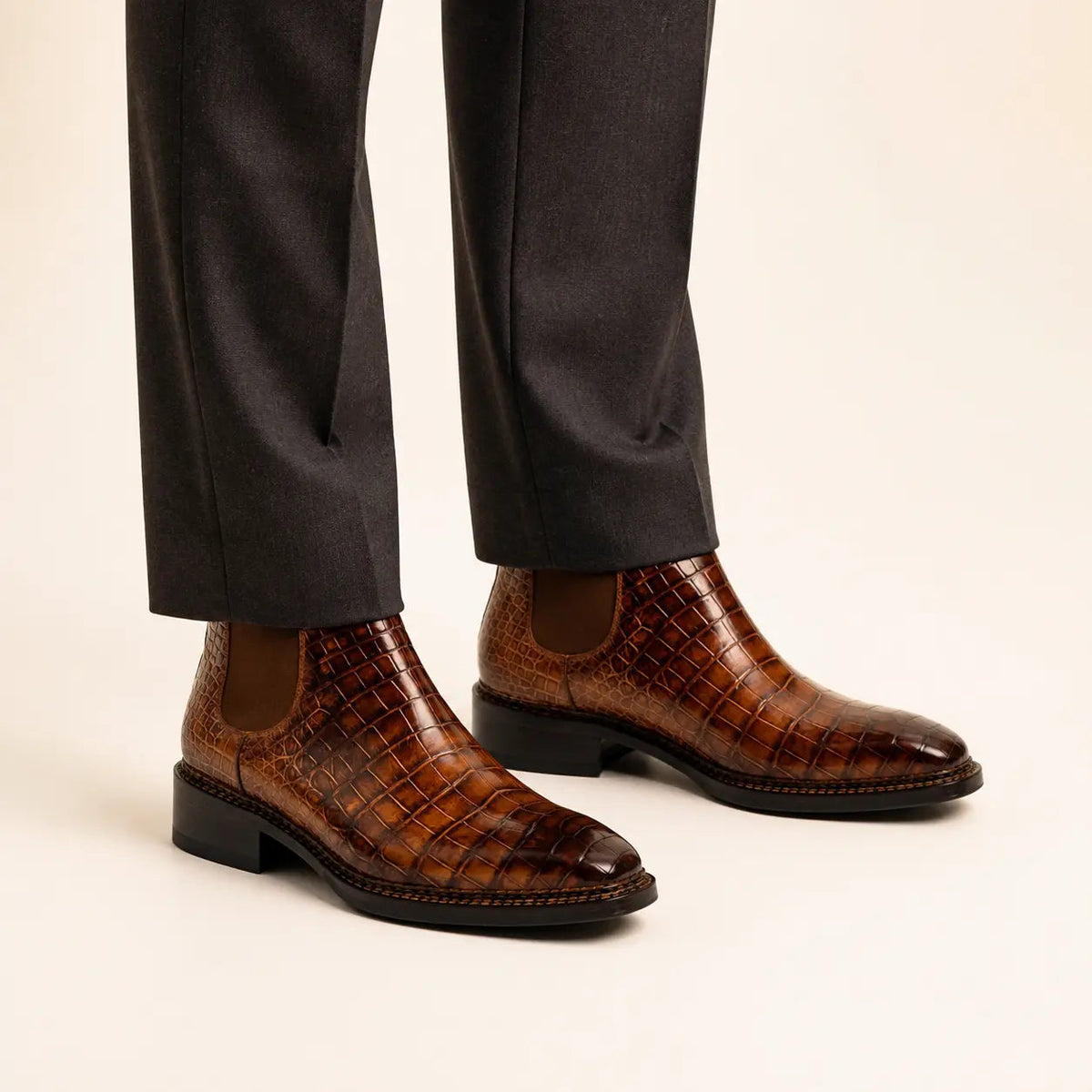 Cognac crocodile Chelsea boots on foot