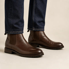 Dark brown Chelsea boots on foot