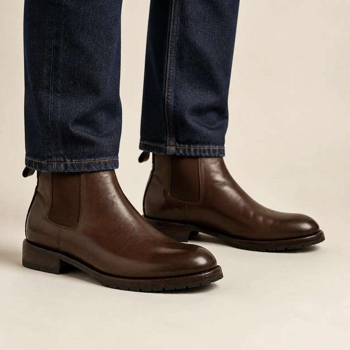Dark brown Chelsea boots on foot