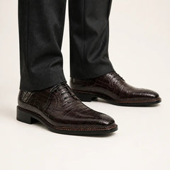 Dark brown crocodile Derby shoes on foot