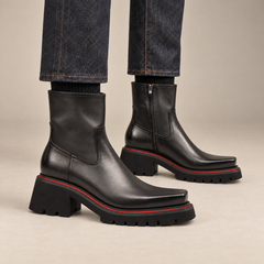Dark gray-black lug sole side-zip ankle boots on foot