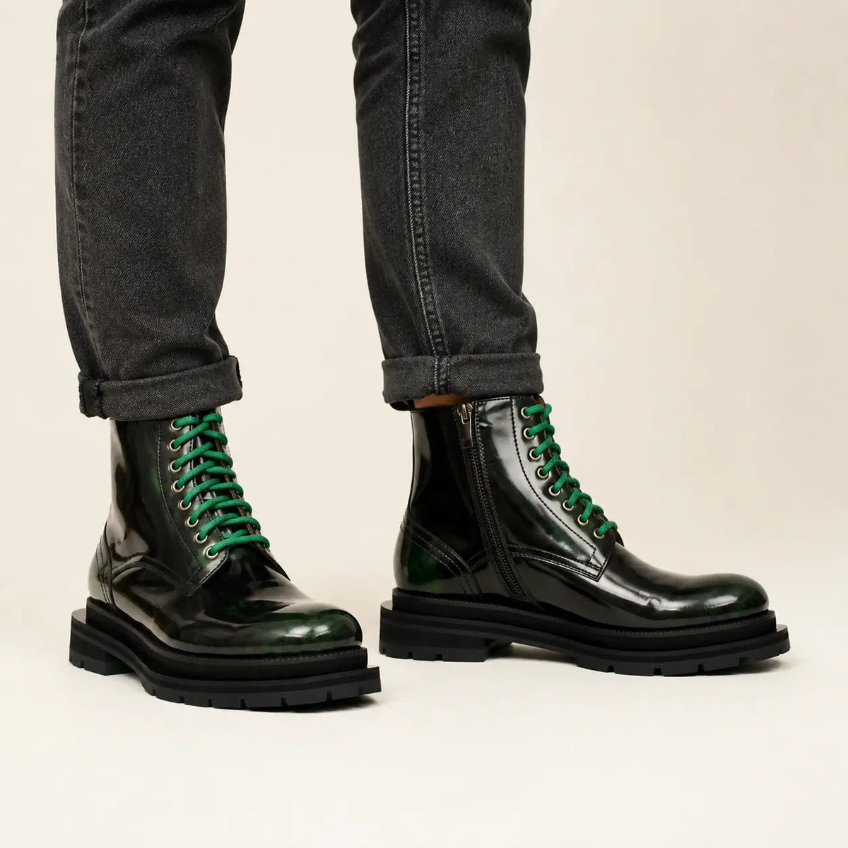 Green-black polished lace-up boots on-foot studio photo