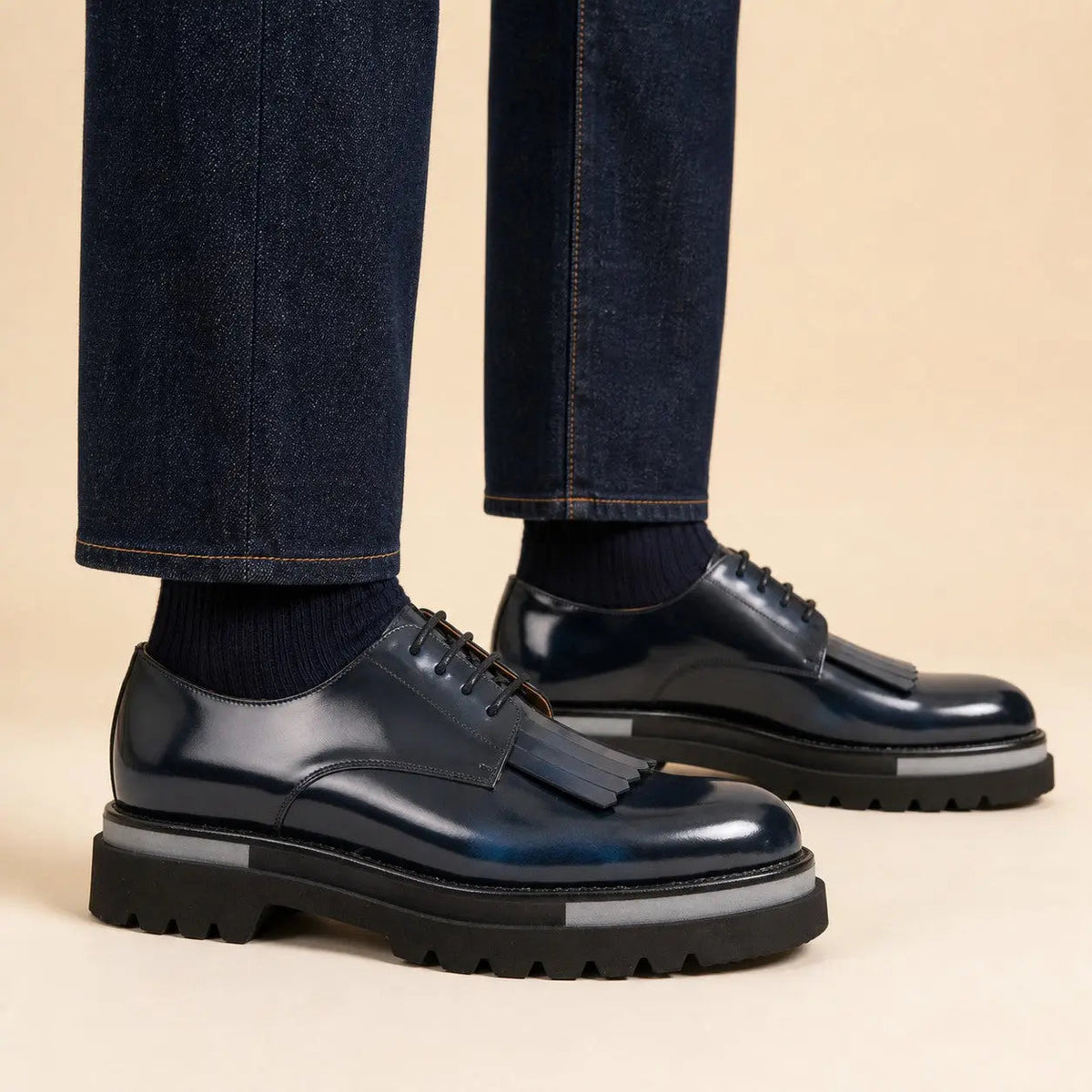 Navy blue patina kiltie Derby shoes on foot