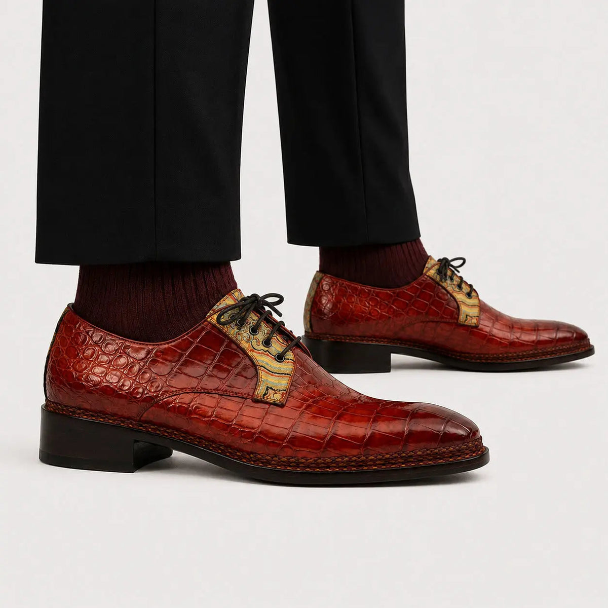 Ruby crocodile Derby shoes worn with black trousers and burgundy socks