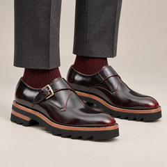 Dark burgundy single monk strap shoes with brown-band lug sole — premium on-foot studio view