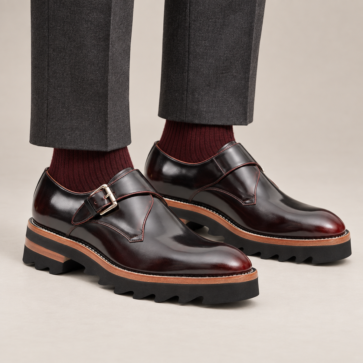 Dark burgundy single monk strap shoes with brown-band lug sole — premium on-foot studio view